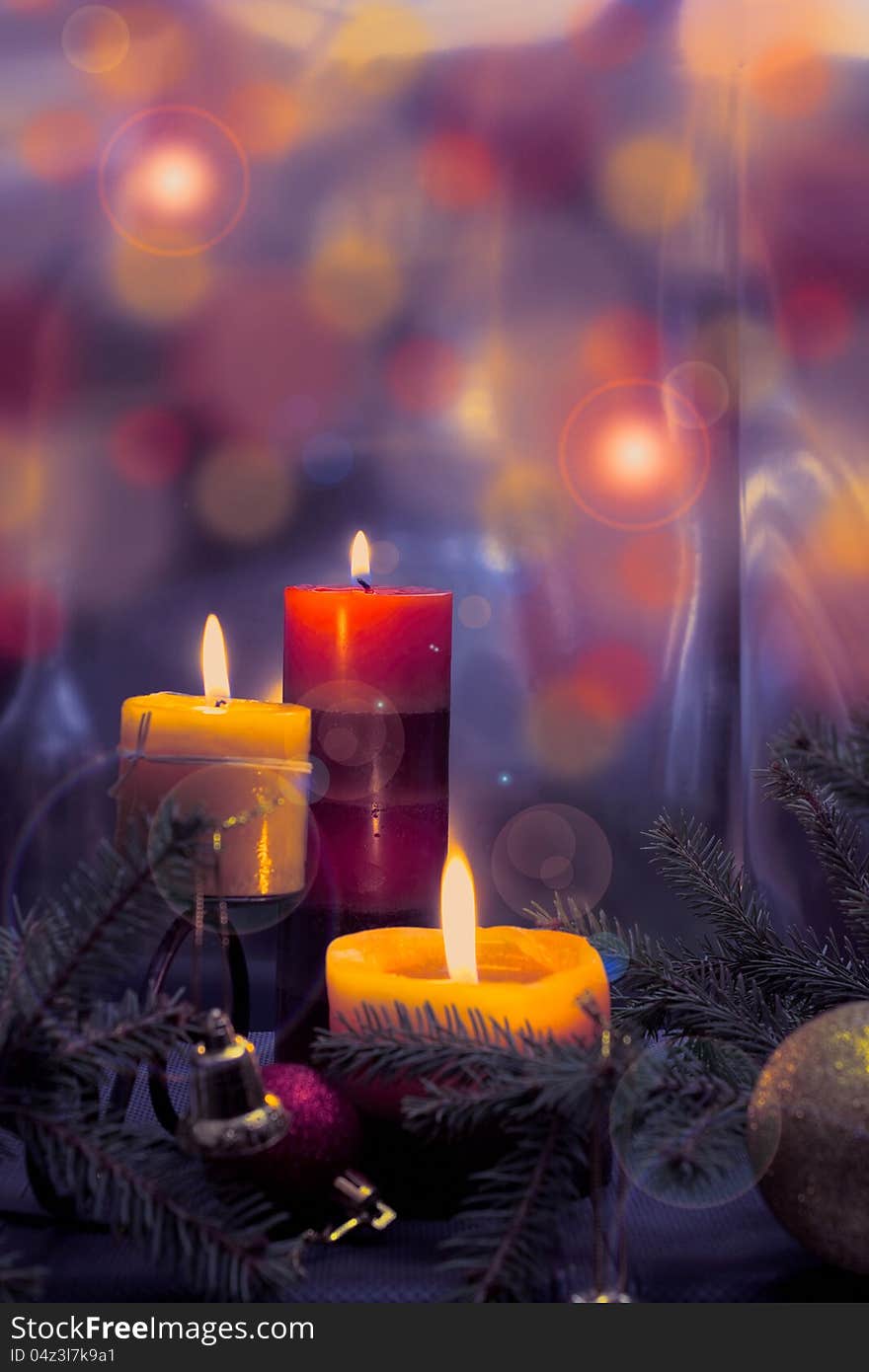 Candles with Christmas balls in atmospheric light