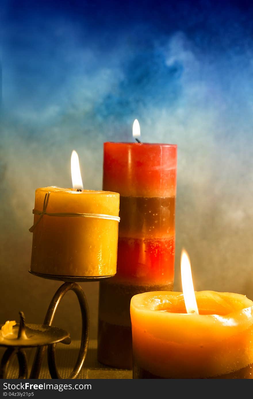 Candles  in atmospheric light on blue background