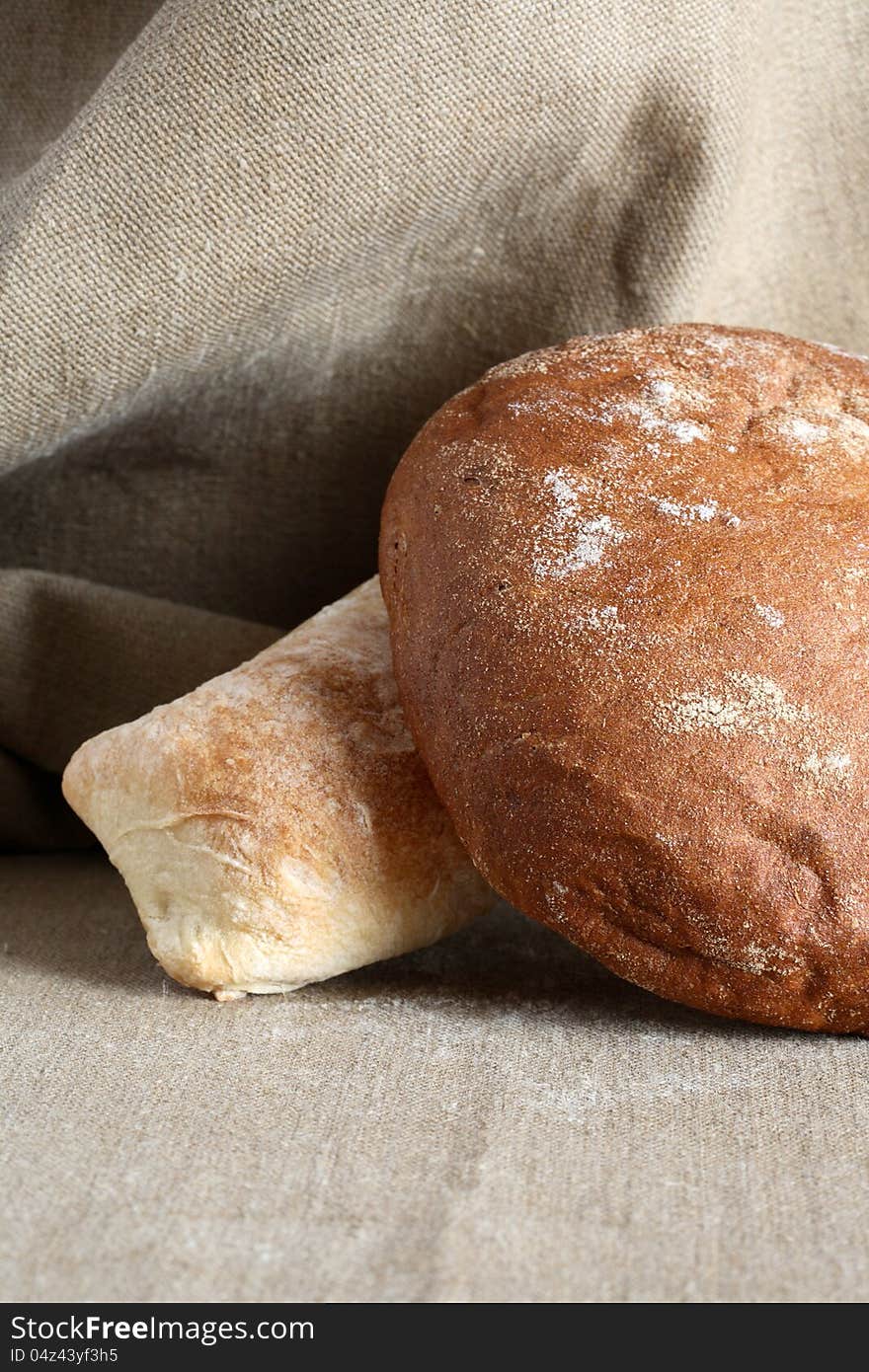 Rye and wheat bread on canvas background