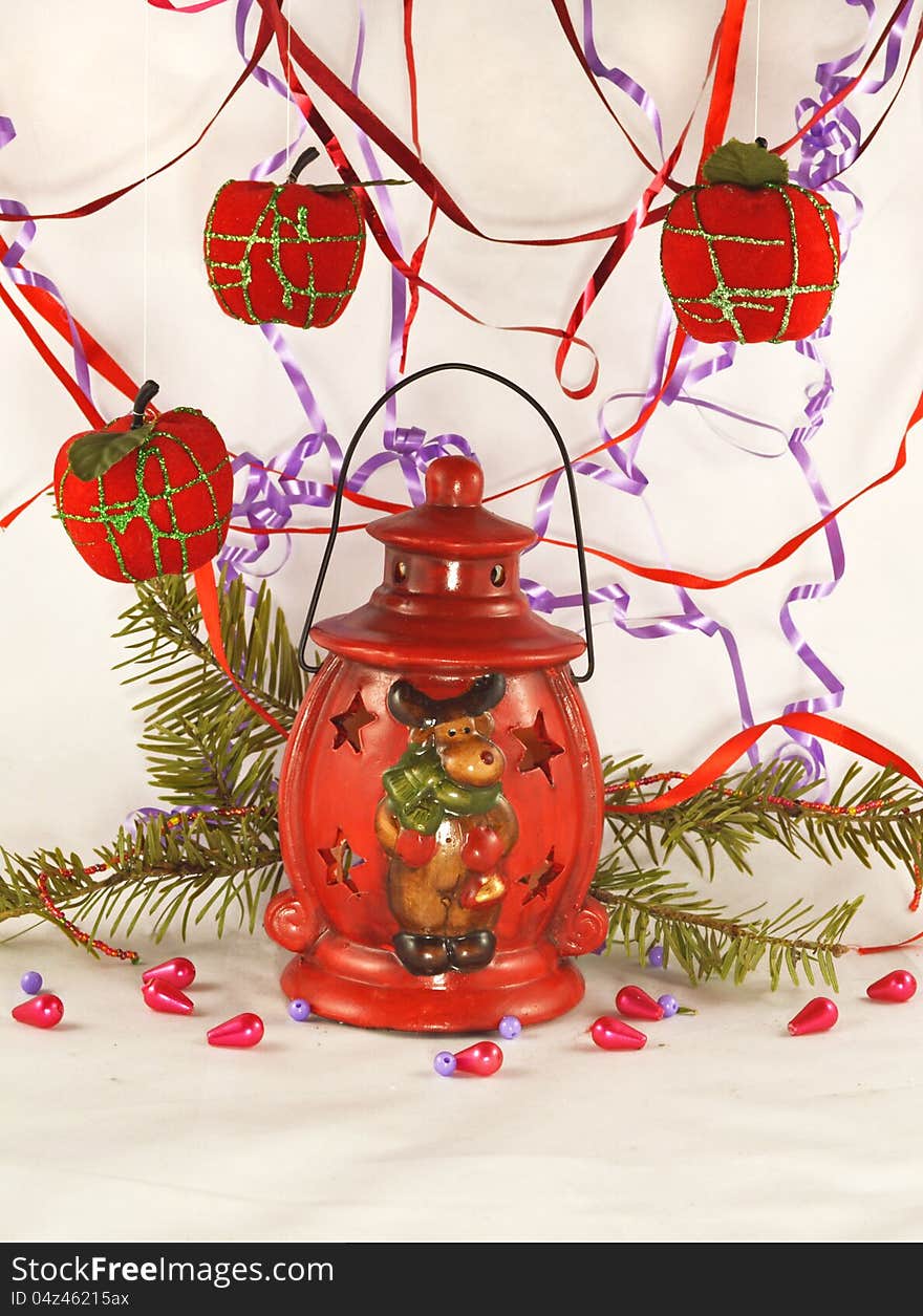 The red lantern with conifer branch, beads and apples