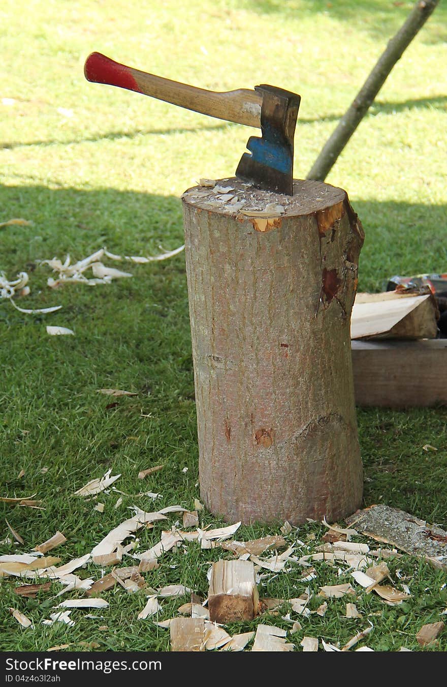 A Hand Axe Placed in a Wooden Chopping Block. A Hand Axe Placed in a Wooden Chopping Block.