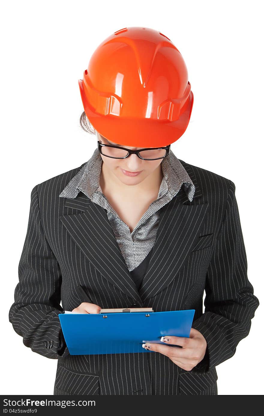 Female superintendent in the construction helmet records the tablet