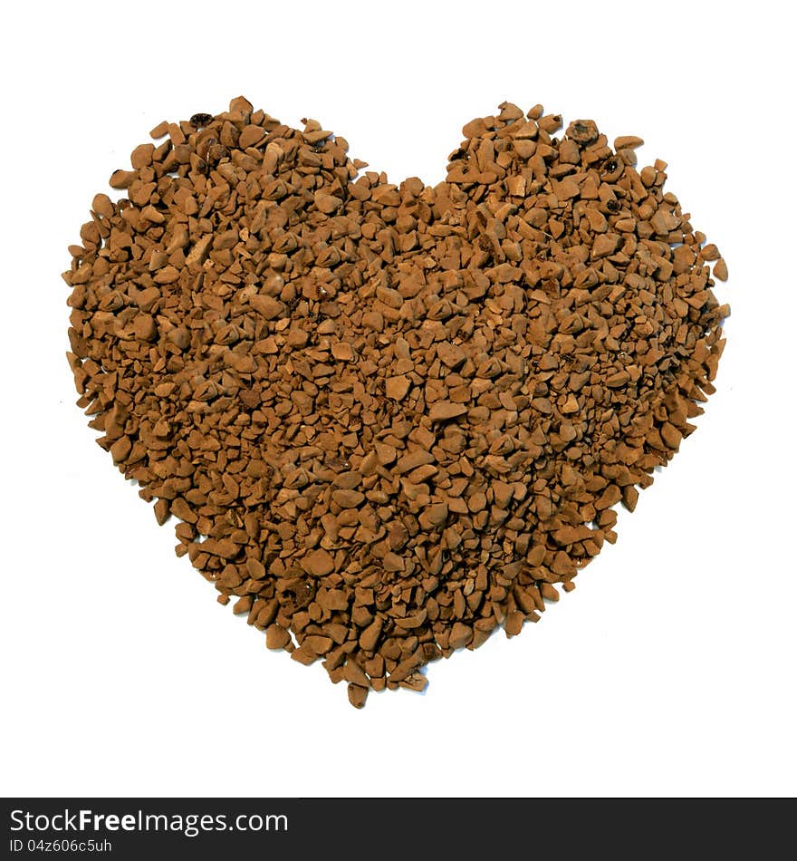 Studio macro image of a heart shape comprising 'instant' coffee granules on a white background. Copy space. Studio macro image of a heart shape comprising 'instant' coffee granules on a white background. Copy space.