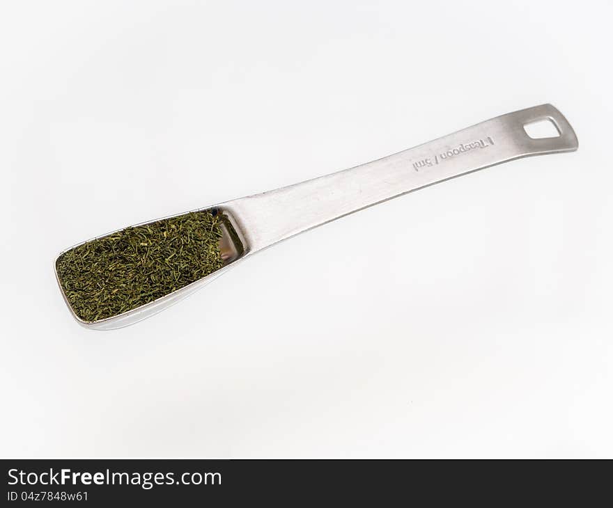 Dried Dill flakes in teaspoon