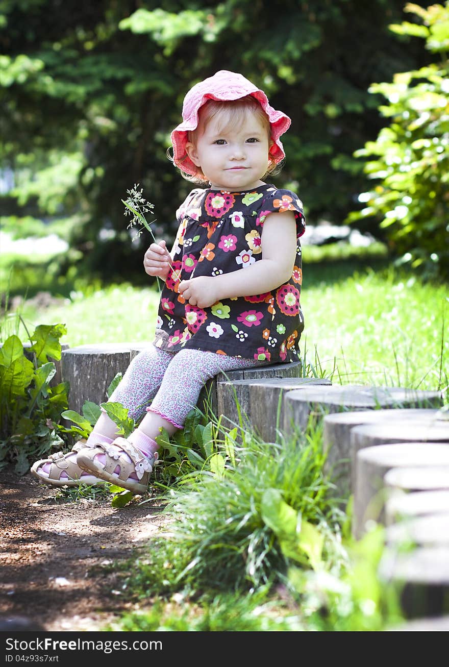 Funny baby girl on a little tree stump. Funny baby girl on a little tree stump