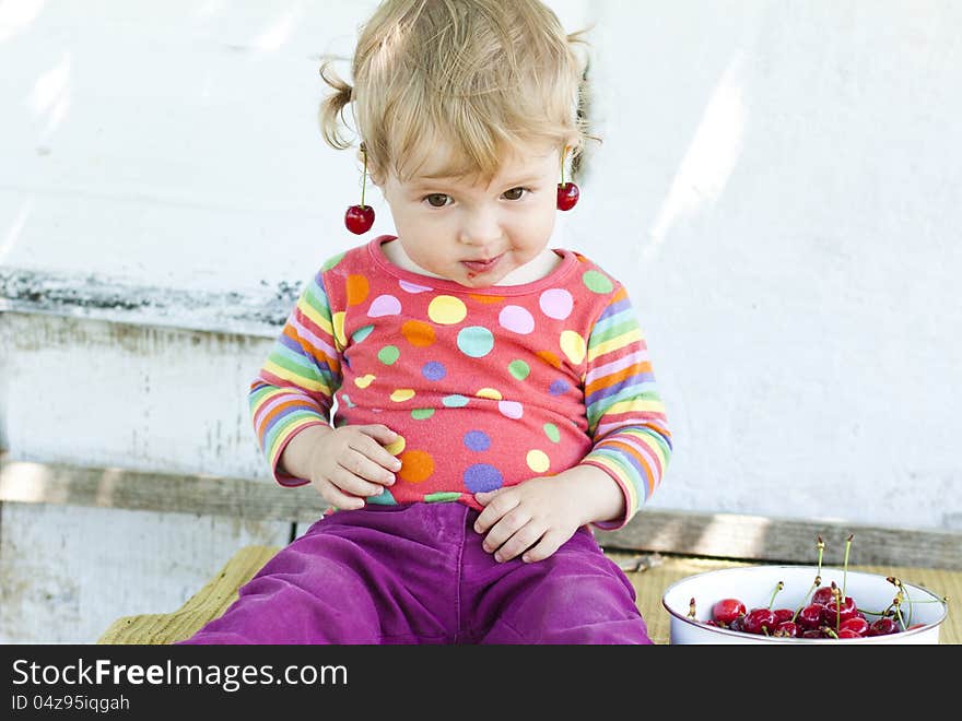 Adorable little girl with a cherry on her ear