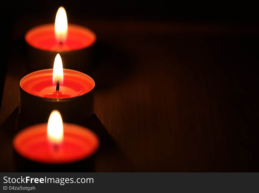 Red candles on dark background