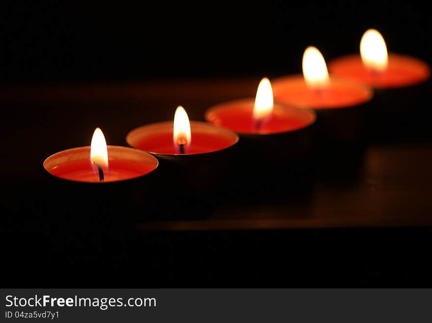 Red candles on dark background