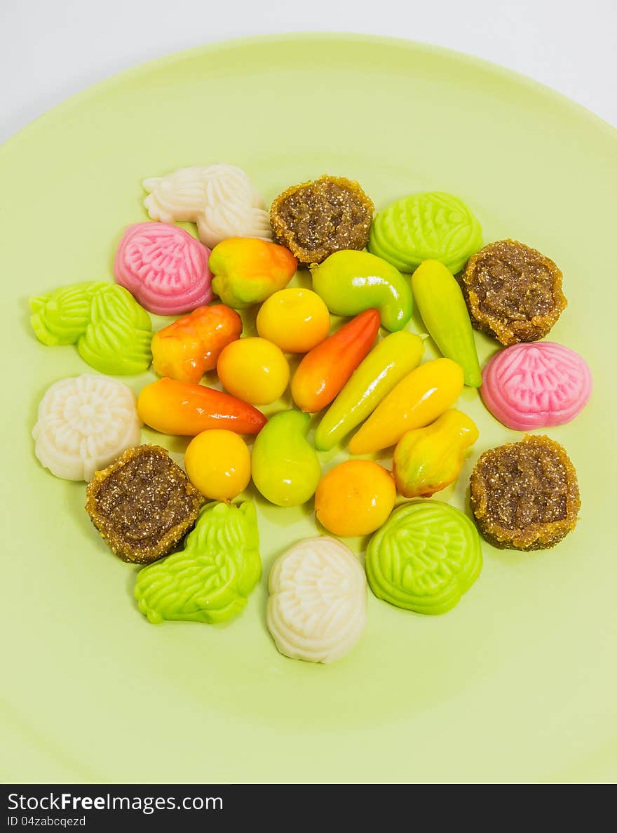 Various colorful Thai dessert on green plate from Phuket shop, Thailand