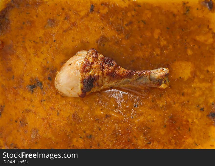 Single roasted chicken thigh laying in gravy