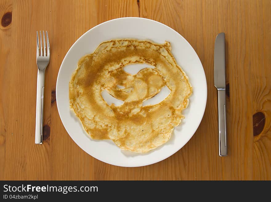 Top view on pancake on white plate