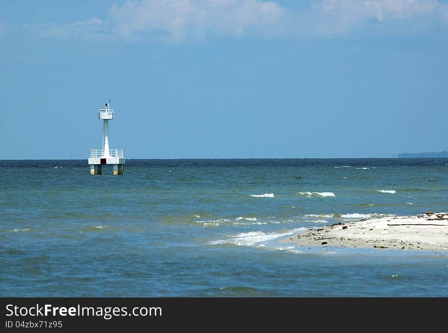 A watch tower stands alone in the middle of the sea. A watch tower stands alone in the middle of the sea