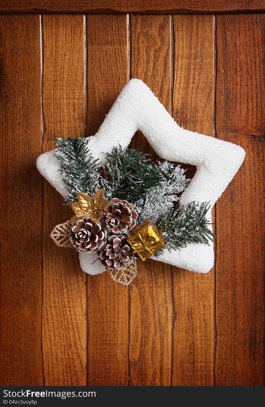 Christmas wreath on the background of wooden wall