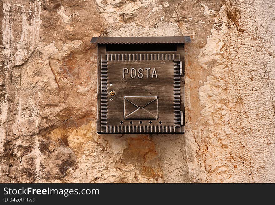 Old mailbox on ancient stone wall