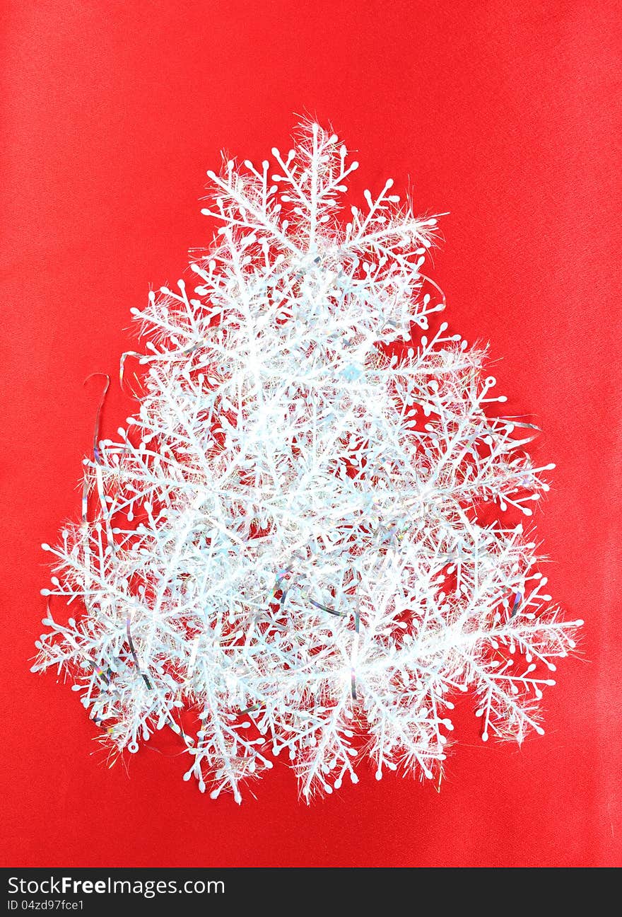 Christmas tree from snowflakes on a red background, christmas decoration. Christmas tree from snowflakes on a red background, christmas decoration