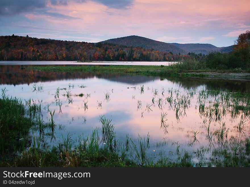 Kent Pond in dusk, with hills and foliage in Autumn, near Killington Vermont. Kent Pond in dusk, with hills and foliage in Autumn, near Killington Vermont