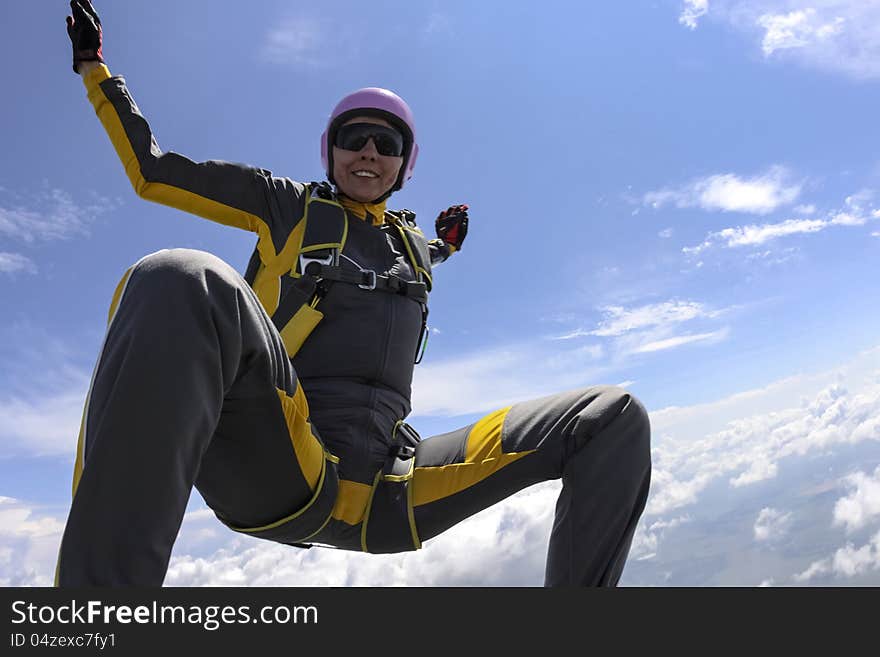 The girl parachutist performs figure freestyle in freefall. The girl parachutist performs figure freestyle in freefall.