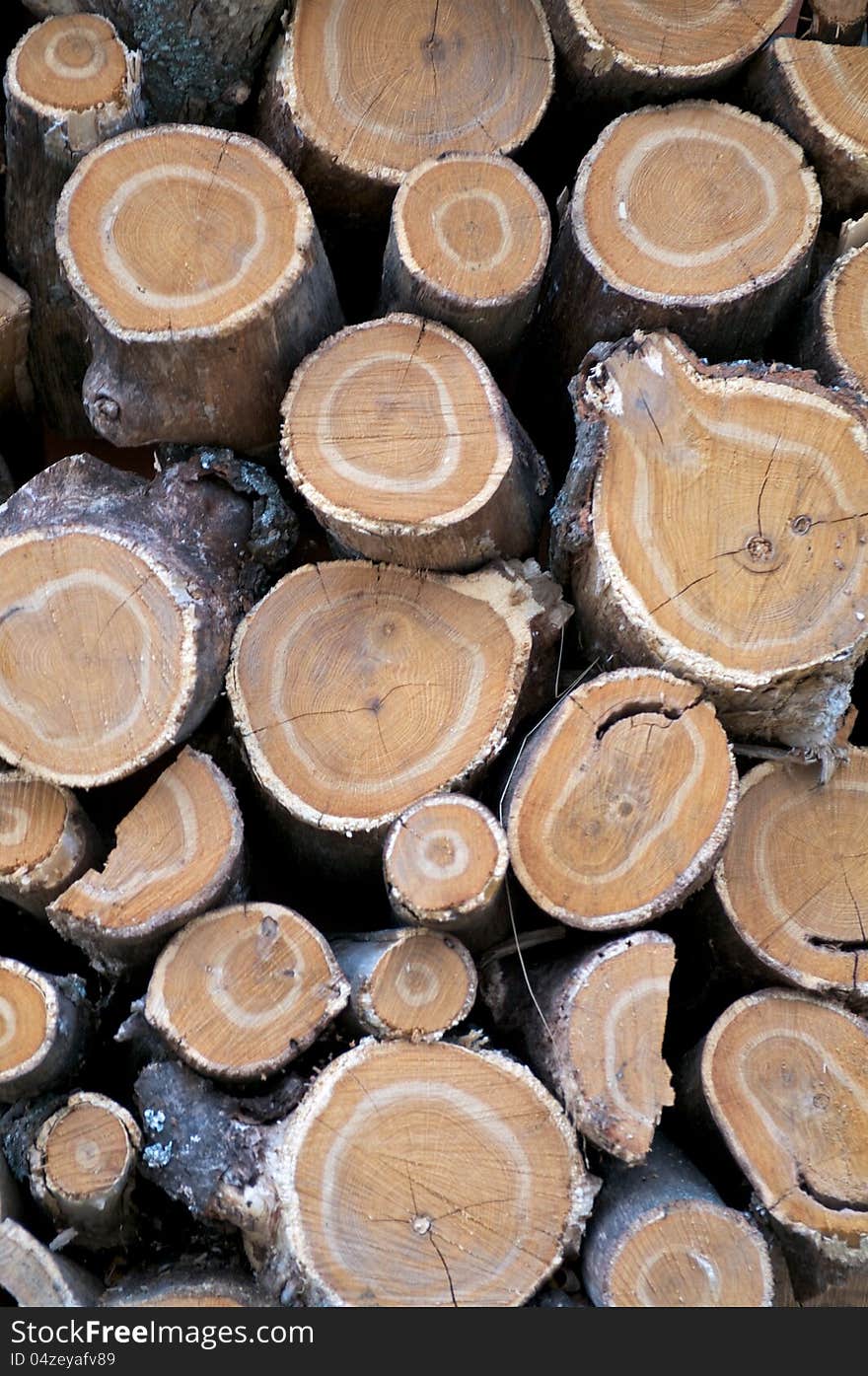 Background of Neatly Stacked Round Logs closeup outdoors. Background of Neatly Stacked Round Logs closeup outdoors