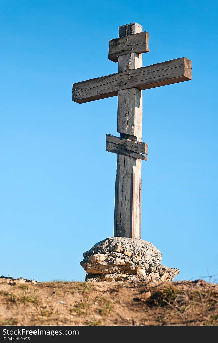 Wooden cross on a background of blue sky. Wooden cross on a background of blue sky