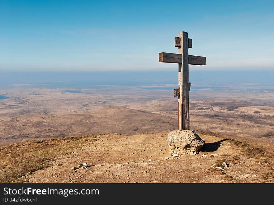 Wooden cross on a background of blue sky. Wooden cross on a background of blue sky