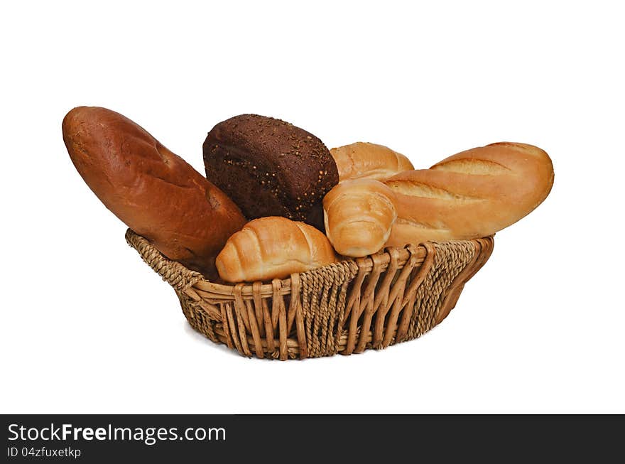 In the wicker basket placed various bread products: wheat, rye, .. small loaves and rolls. In the wicker basket placed various bread products: wheat, rye, .. small loaves and rolls.