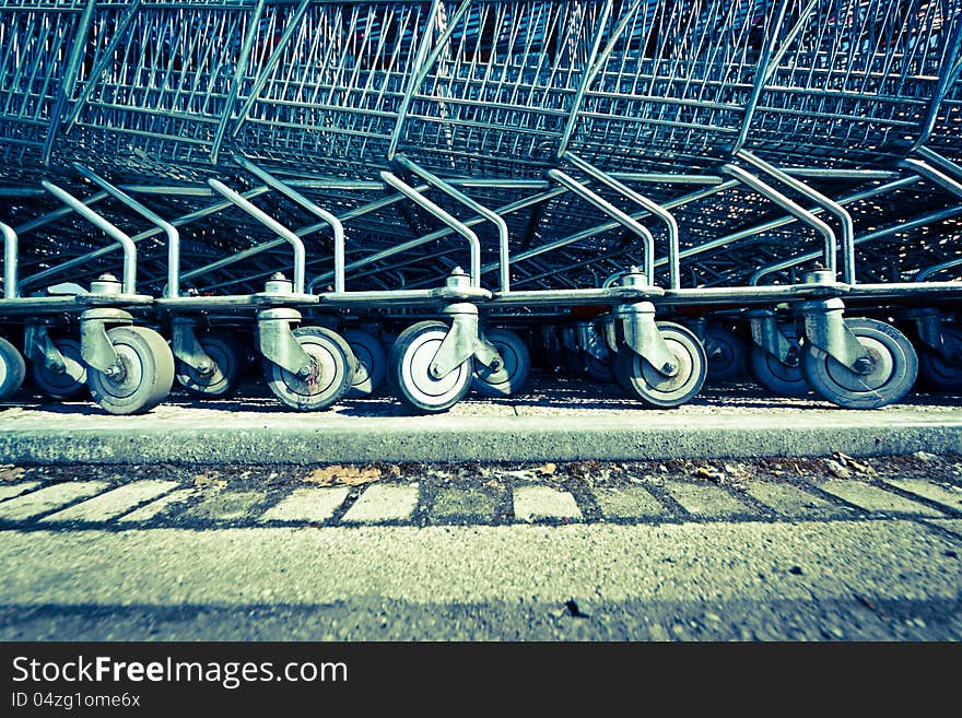 A series of shopping trolleys are placed in a row