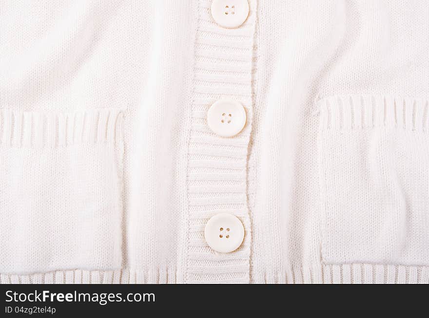 Knitted white jersey texture with a button