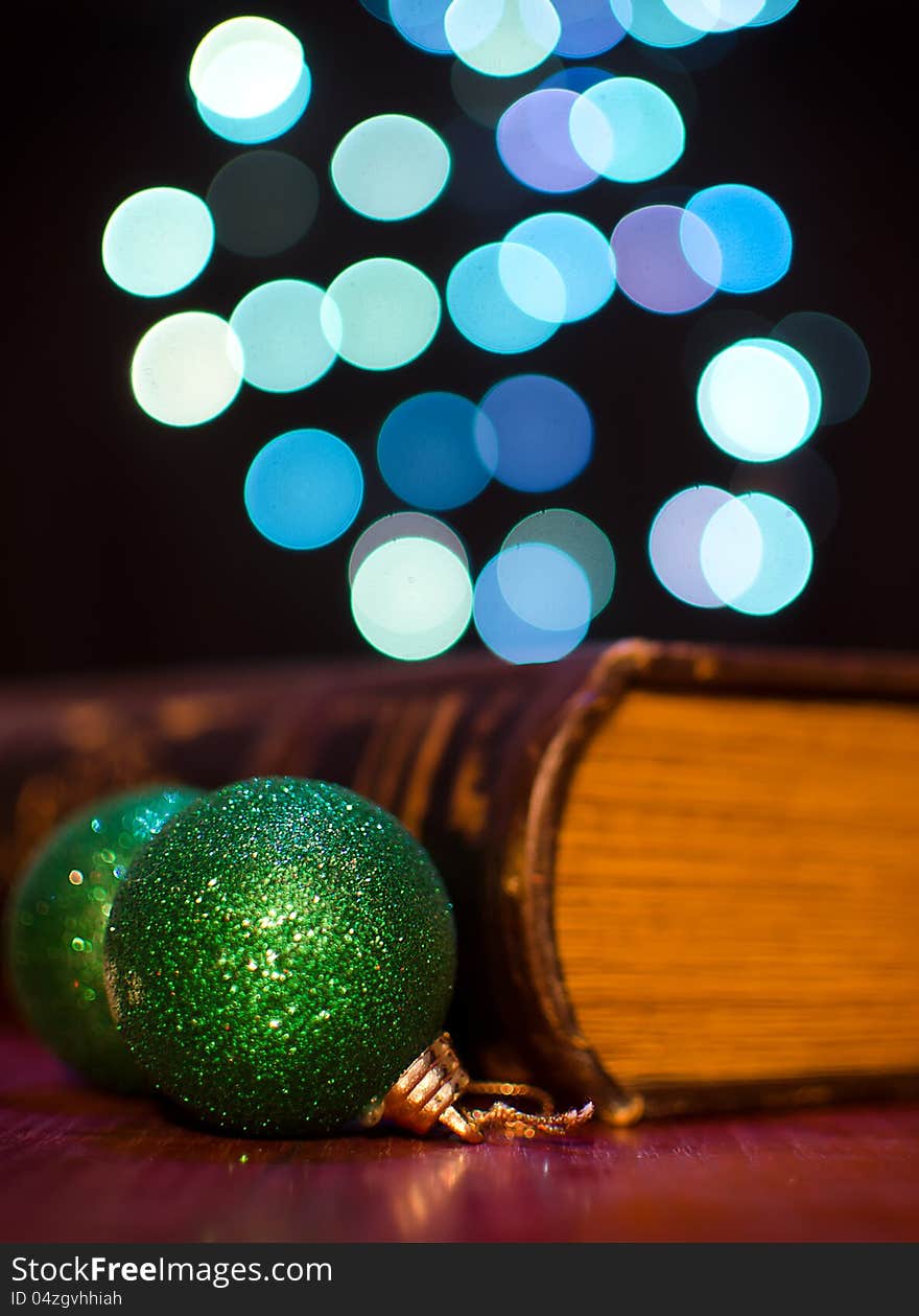 Old book and seasonal decorations on bokeh lights background