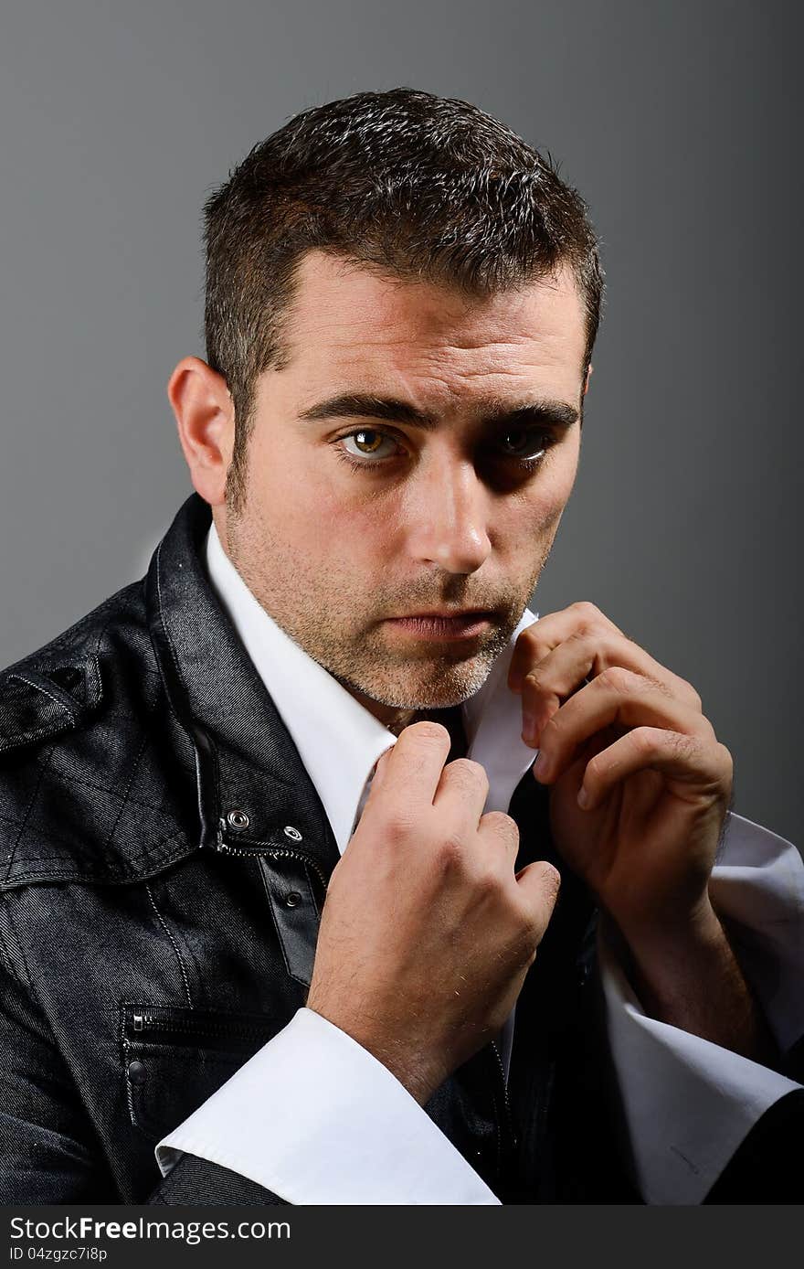 Close up studio portrait of a serious man on black background