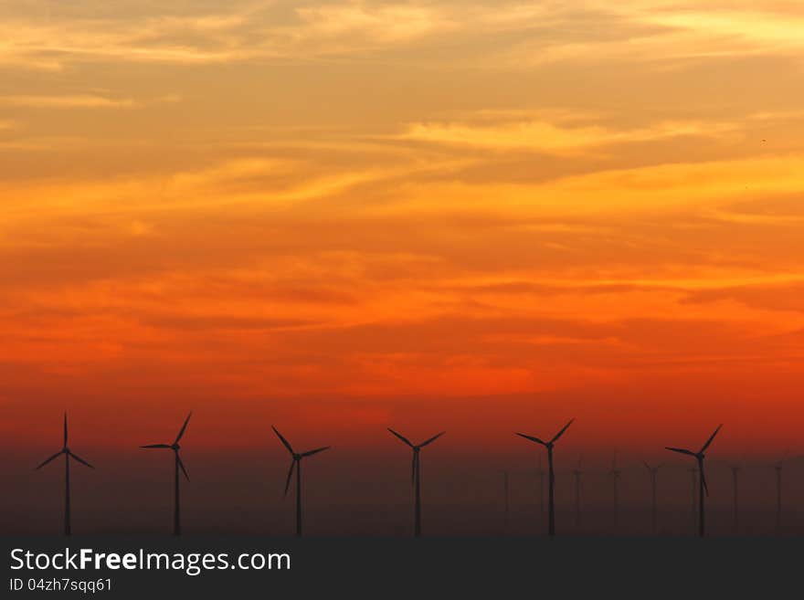 Wind turbines at sundown on the Austrian-Slovak border. Wind turbines at sundown on the Austrian-Slovak border.