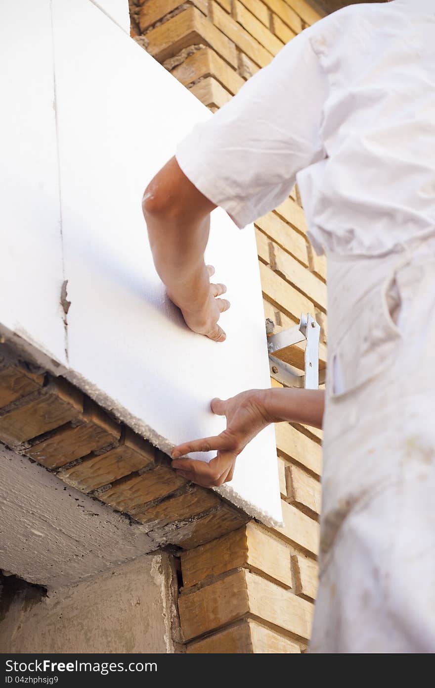 Painters working on the building-wall insulation