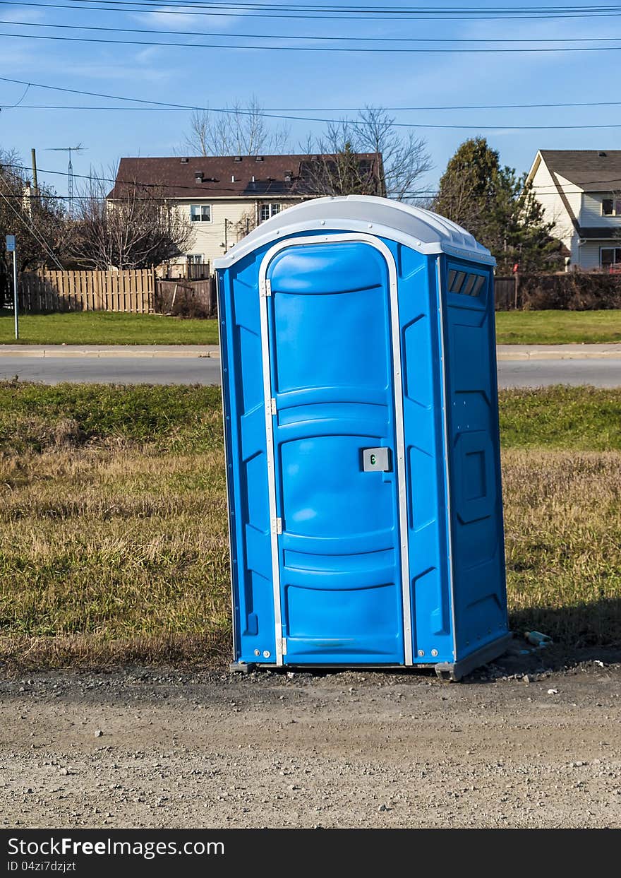 Portable toilets outdoors beside a road