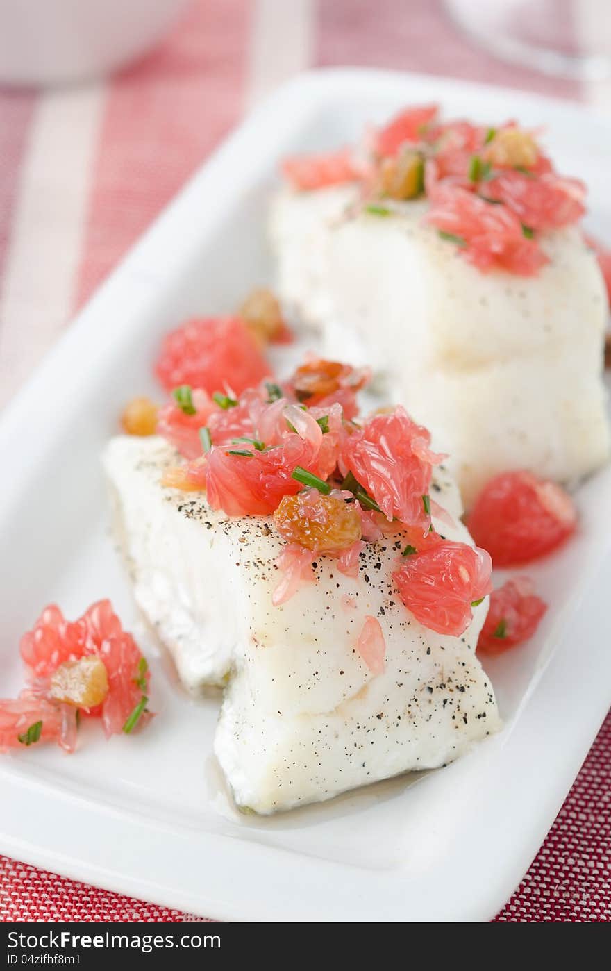 Baked cod with grapefruit salsa selective focus