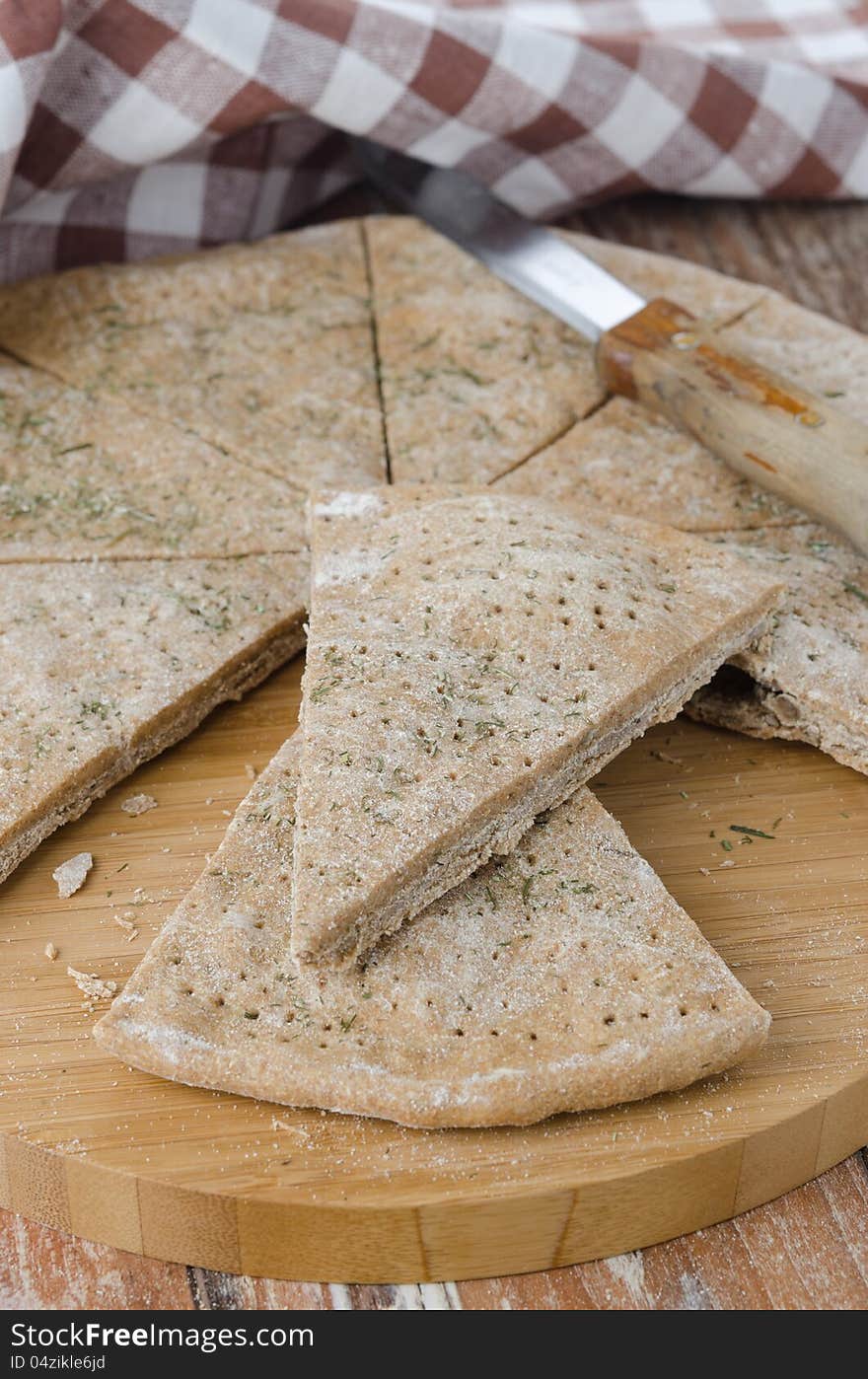 Cut portions flat bread made ​​from rye flour with dill. Cut portions flat bread made ​​from rye flour with dill