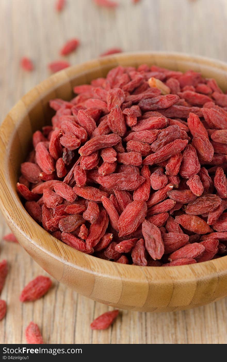 Wooden bowl with goji berries on the table closeup. Wooden bowl with goji berries on the table closeup