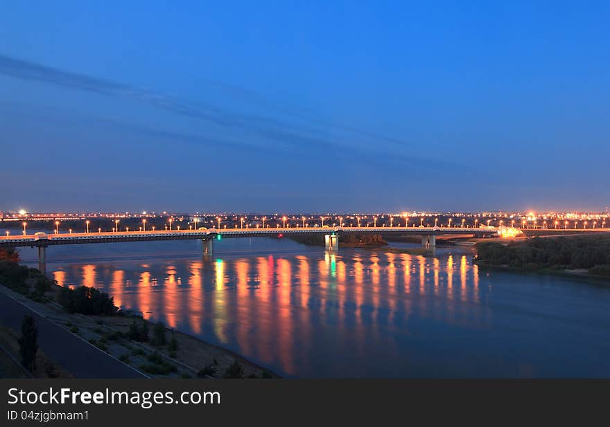 Bridge named after the sixtieth anniversary of victory. Irtysh River. Omsk. Russia. Night landscape. Bridge named after the sixtieth anniversary of victory. Irtysh River. Omsk. Russia. Night landscape.