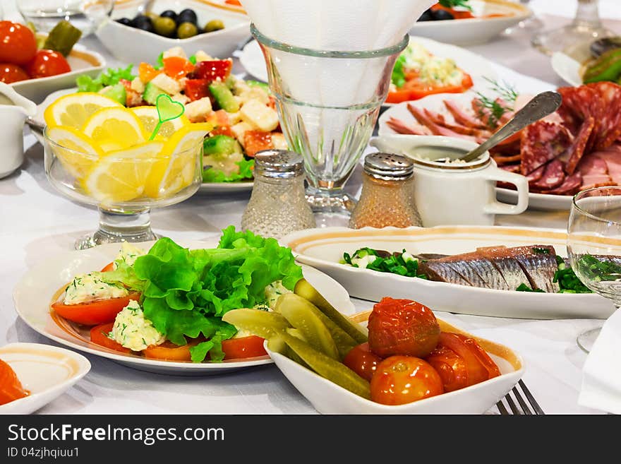 Fresh salads and fish on holiday table