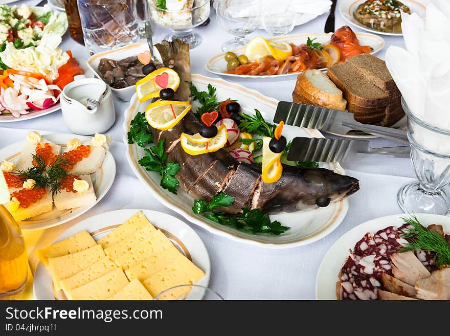 Fresh fish and snacks on holiday table