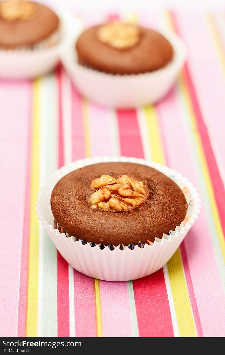 Chocolate cupcakes with on color background