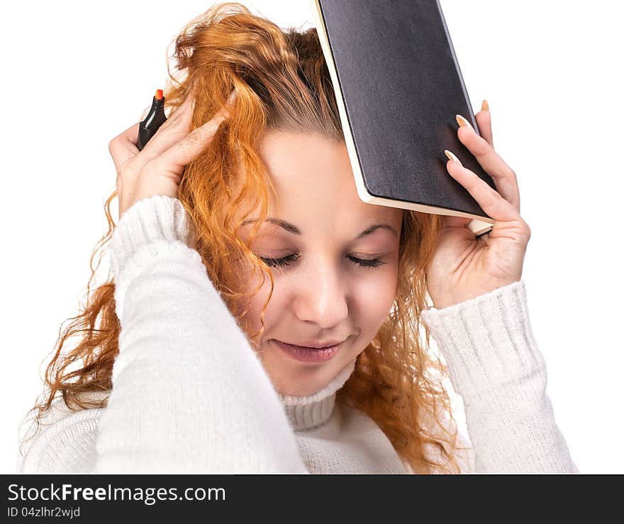 Education. Tired girl holds a notebook on her head on a white background. Education. Tired girl holds a notebook on her head on a white background