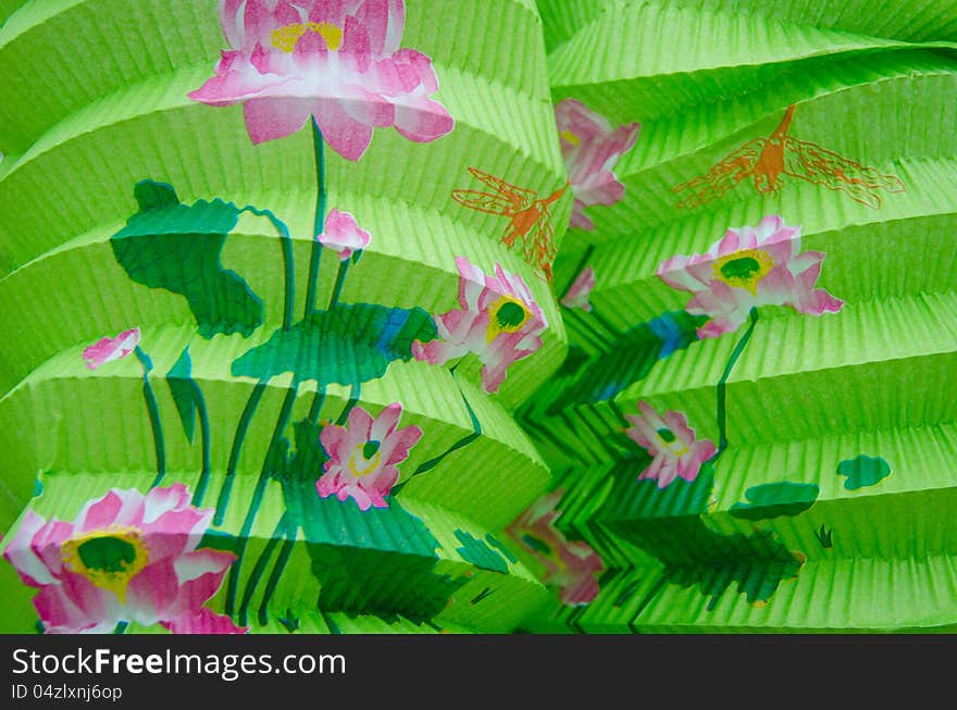 Closeup of two green Chinese paper lanterns with a floral design for a New Year's celebration