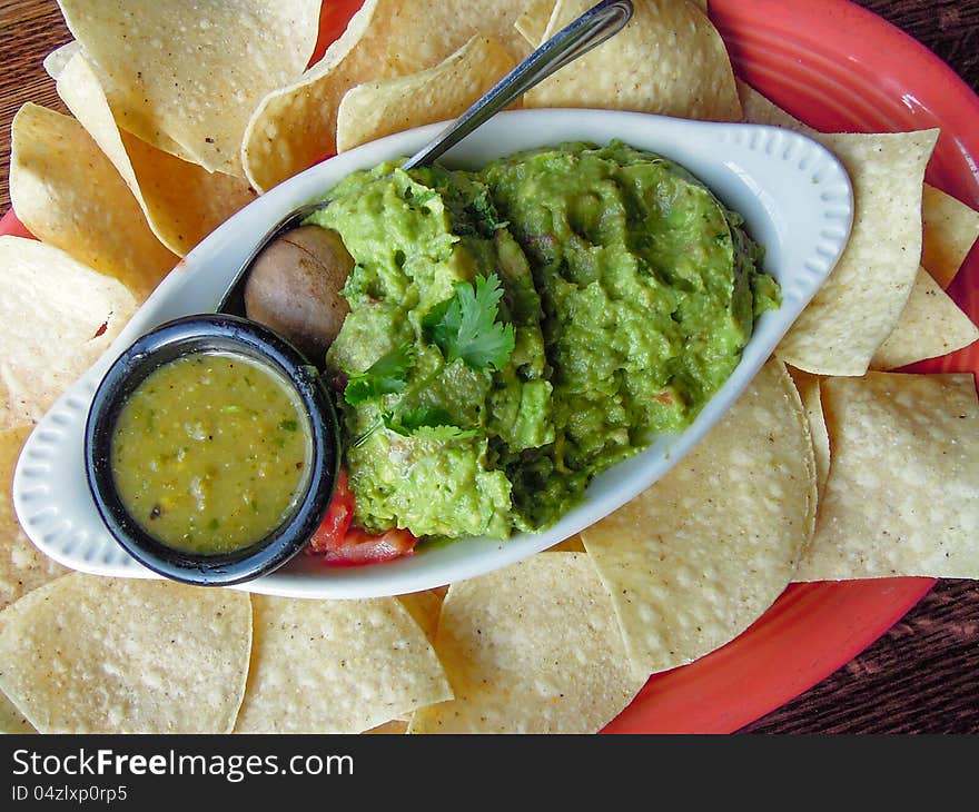 Closeup of guacamole with tortilla chips served on a plate