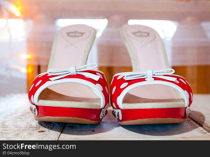 A bride's wedding shoes in red and white with polkadots and heels. A bride's wedding shoes in red and white with polkadots and heels.