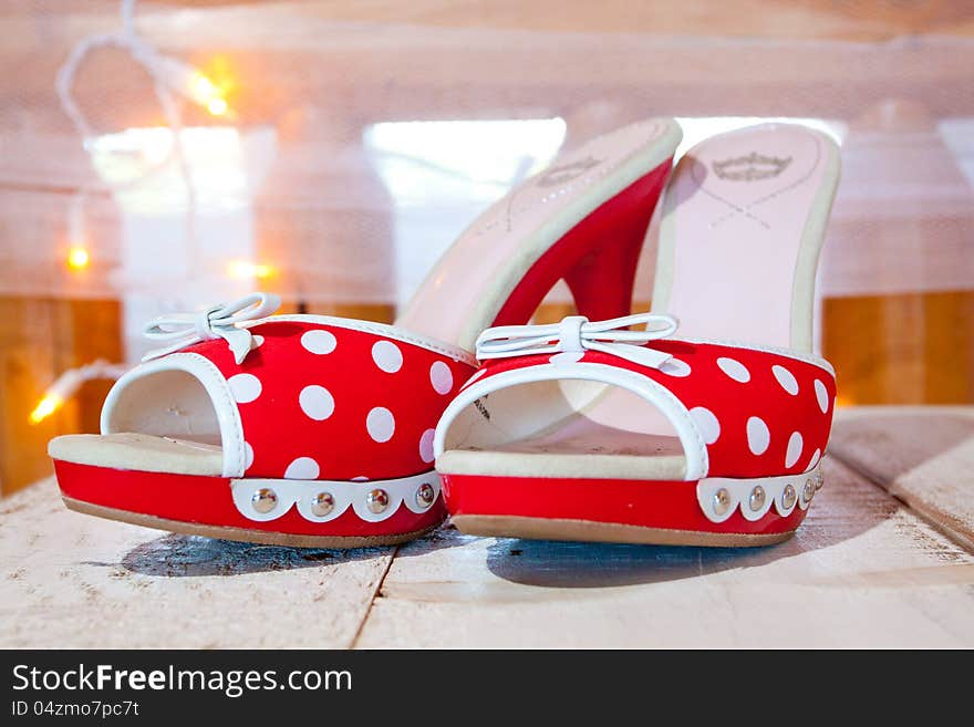 A bride's wedding shoes in red and white with polkadots and heels. A bride's wedding shoes in red and white with polkadots and heels.