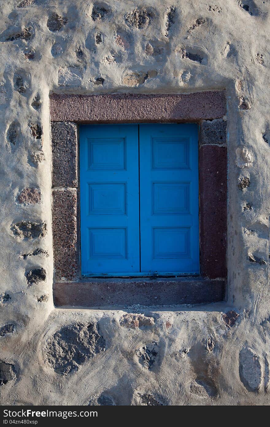 Old window closed blue shutters, Greece, Santorini island