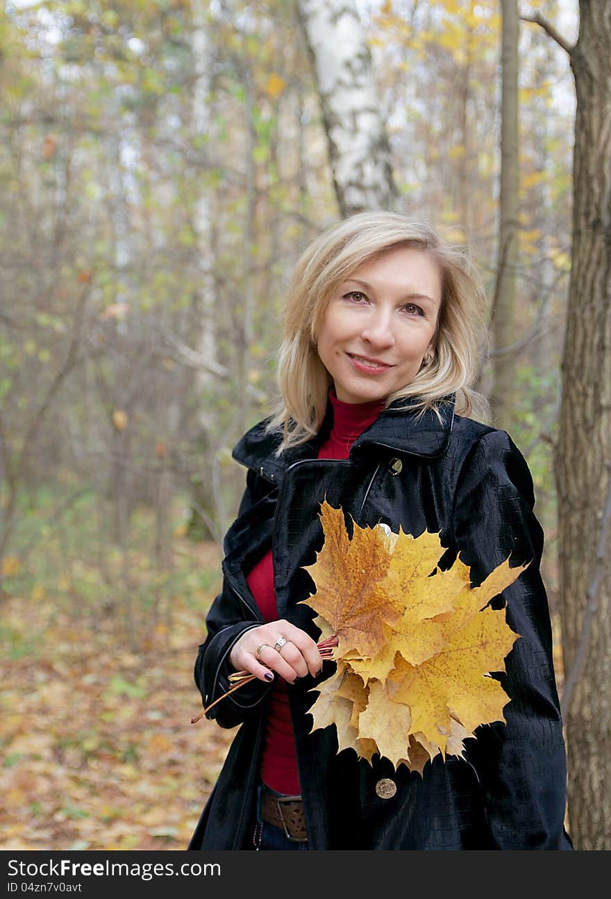 Woman Holding Autumn Leaves