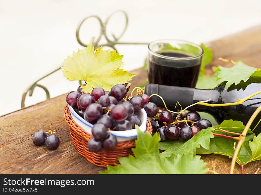 Fresh grapes and bottles of wine