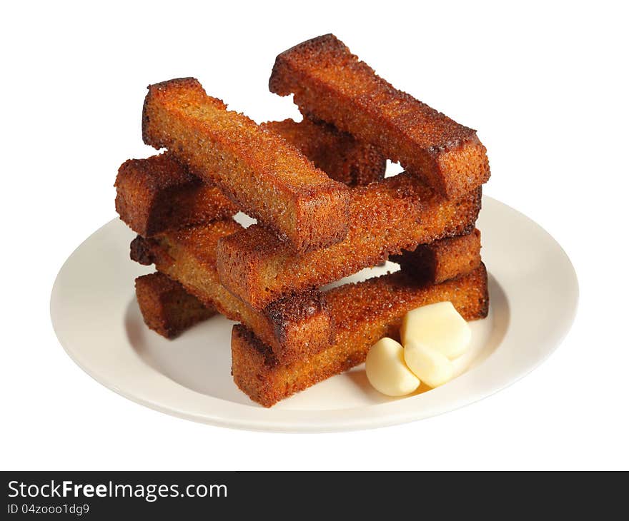 Eight well-built roasted croutons with garlic on white dish isolated on a white background. Eight well-built roasted croutons with garlic on white dish isolated on a white background