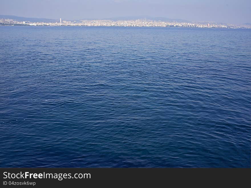 Large city in the distance around the island