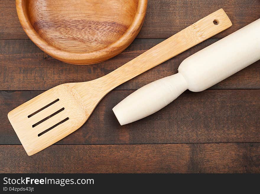 Wooden kitchen utensil: plate, rolling pin, spoon for stirring,top view